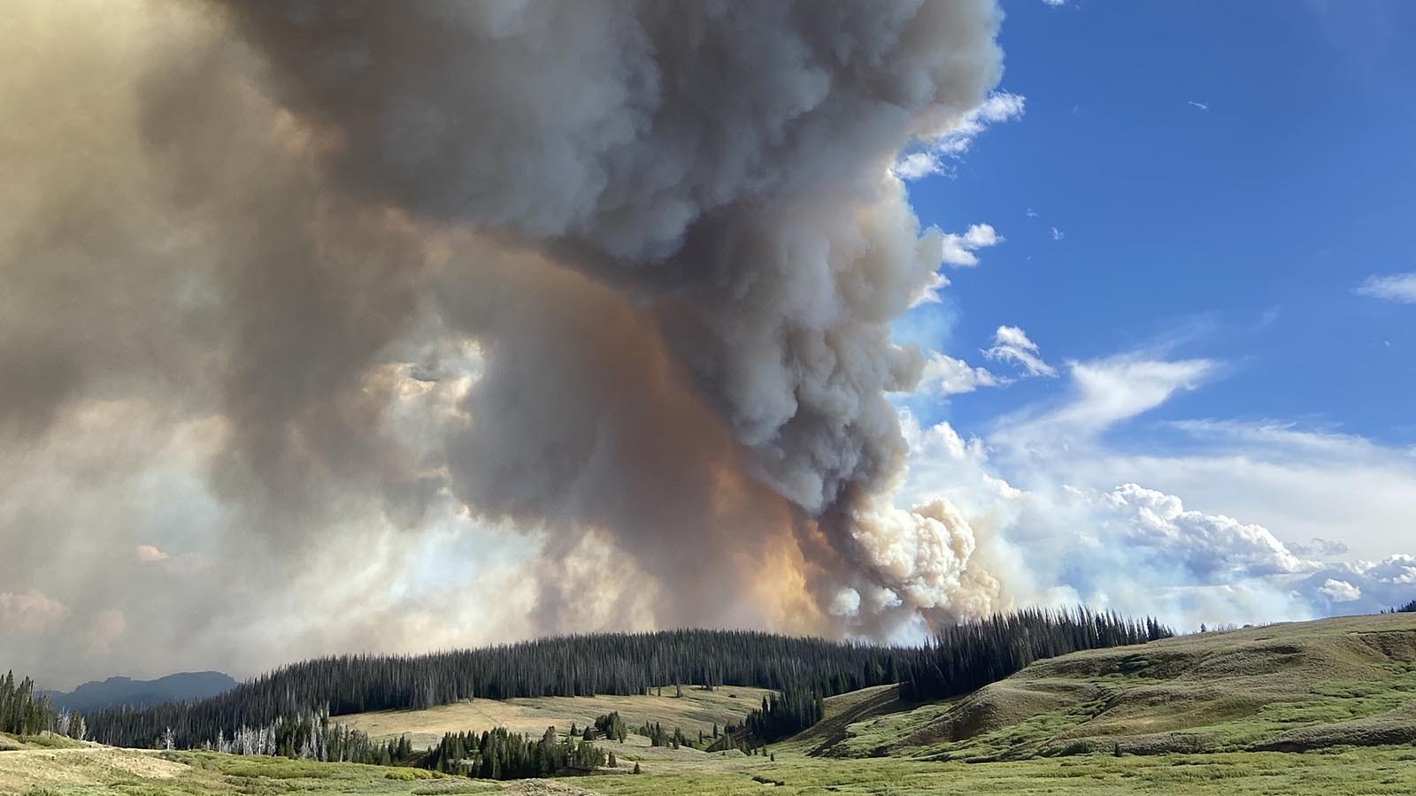 Smoke churns from the Fish Creek Fire, which is devouring dead trees off of Togwotee Pass in northwest Wyoming.