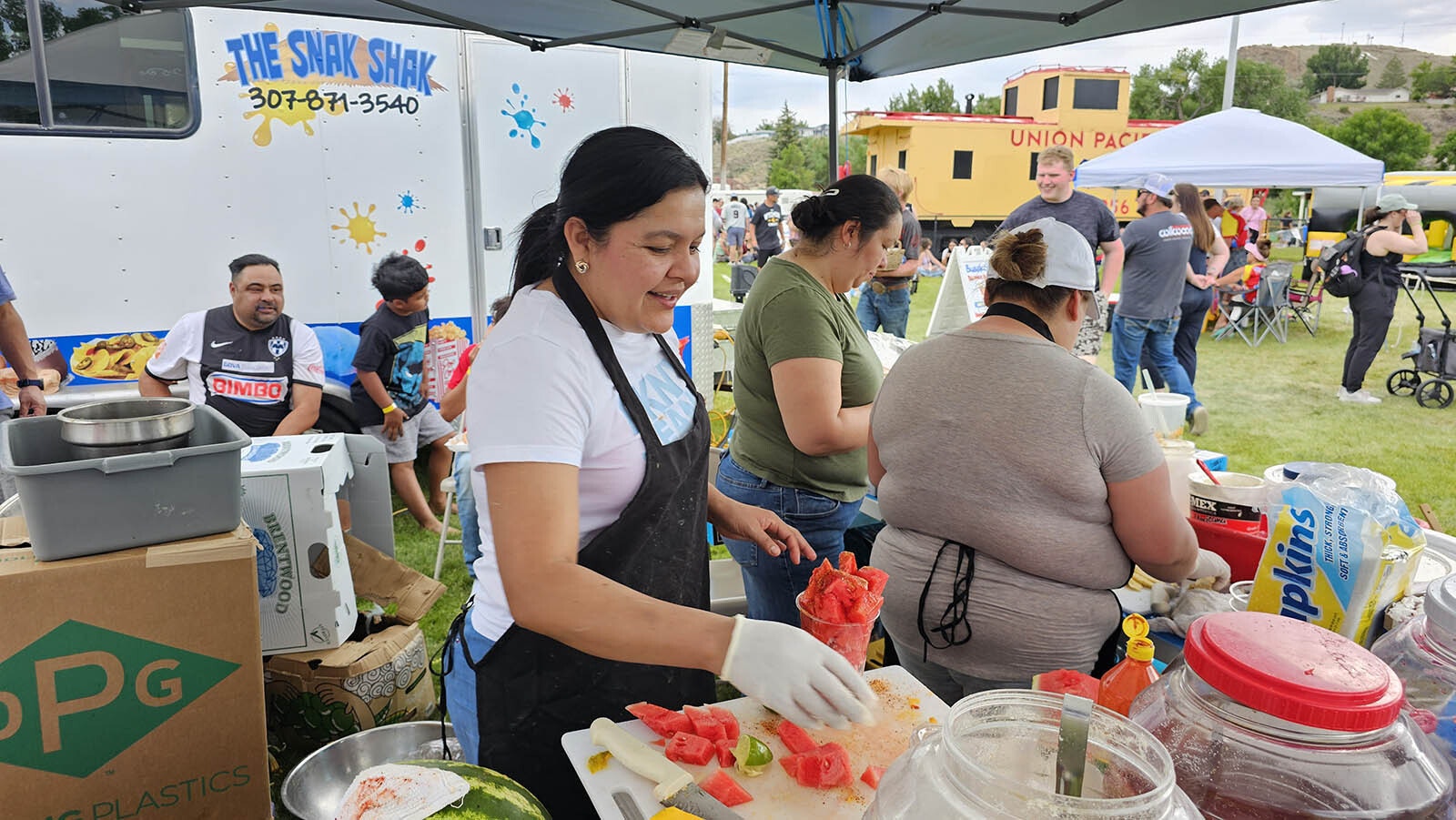 A worker chops up watermelon for a refreshing Mexican fruit salad.