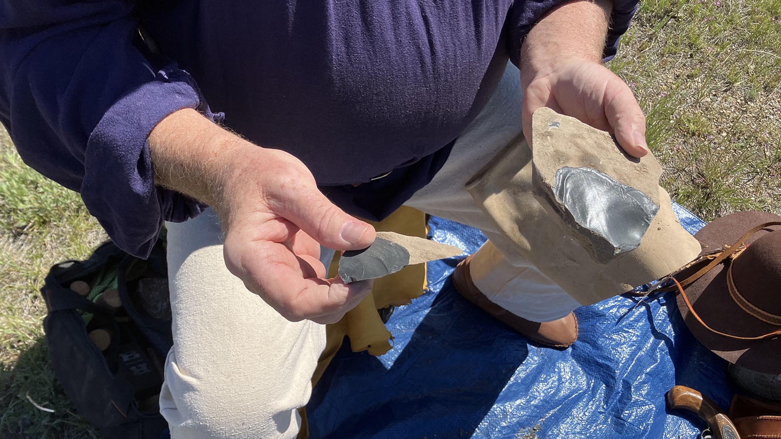 Jim Shipley demonstrates the result of his strike on the rock. It produced a sharp piece of rock that can be made into a tool.