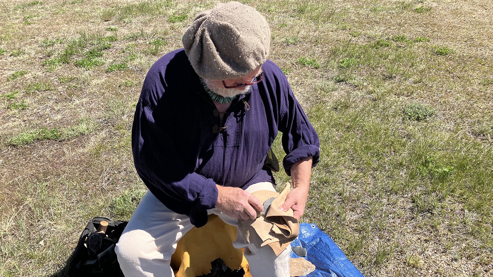 Jim Shipley prepares to strike a piece of Kentucky hornstone with a rock he picked up from a campfire pit.