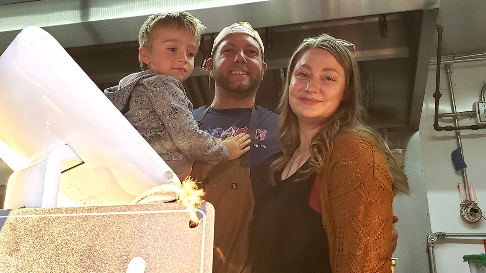 Daniel and Shelby Krugman, pictured here with their son, own Olio Food Truck.