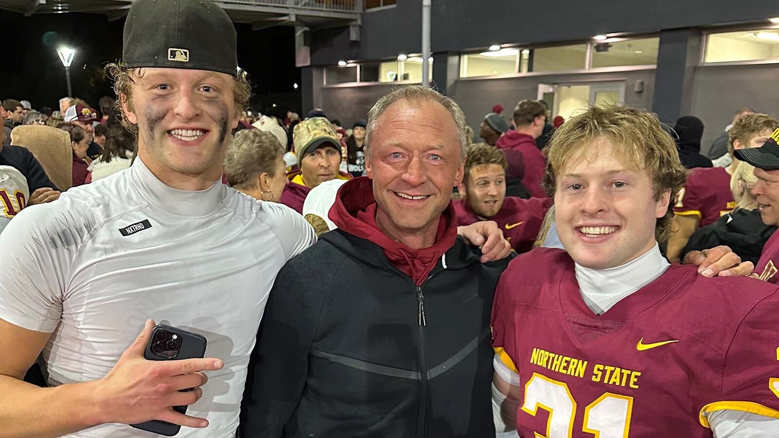 Richard Prescott, his dad Steve, and Brock Pedersen celebrate after a game.