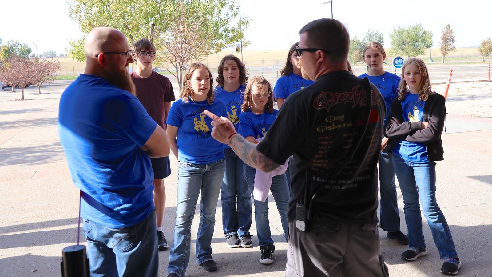 Members of the Shoshoni High School choir receive instruction from the Foreigner stage manager.