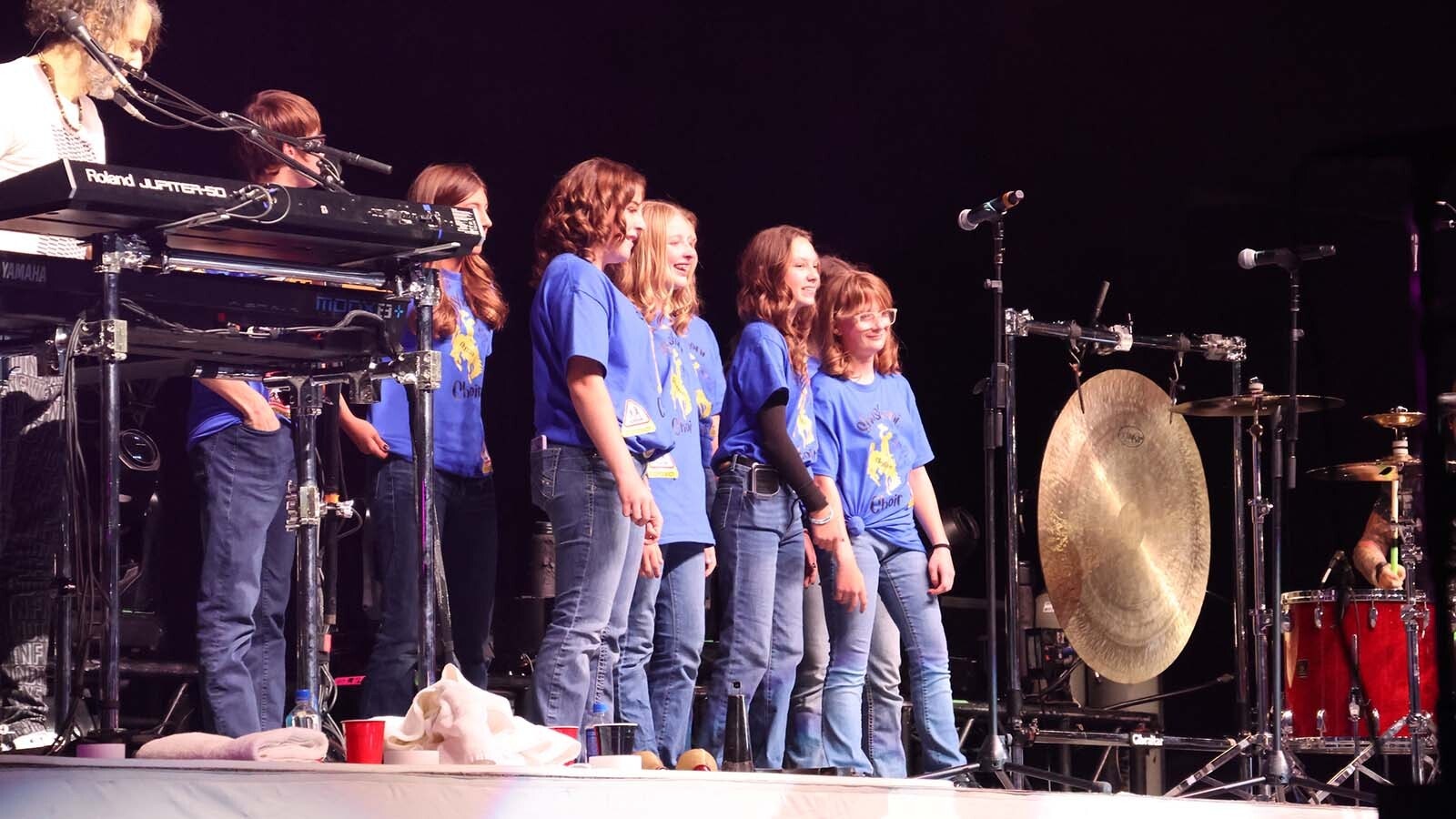 The Shoshoni High School choir gets their moment under the lights on stage with Foreigner.