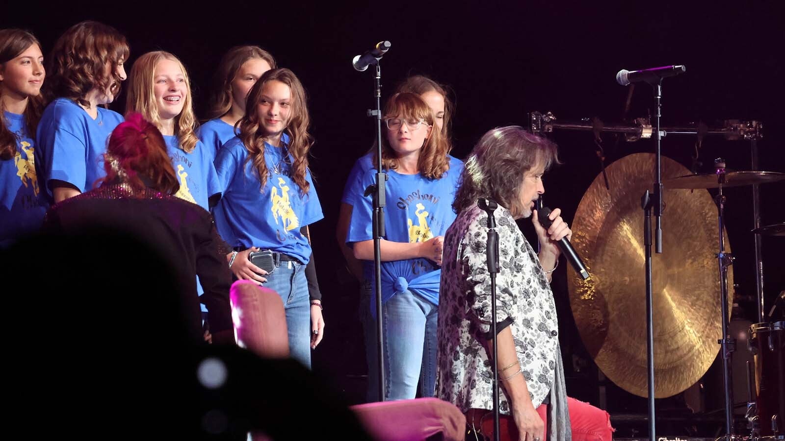 The Shoshoni High School choir gets their moment under the lights on stage with Foreigner.