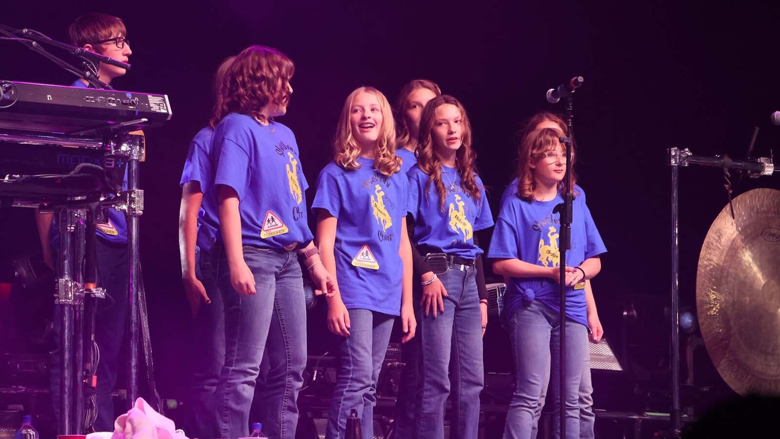 The Shoshoni High School choir gets their moment under the lights on stage with Foreigner.