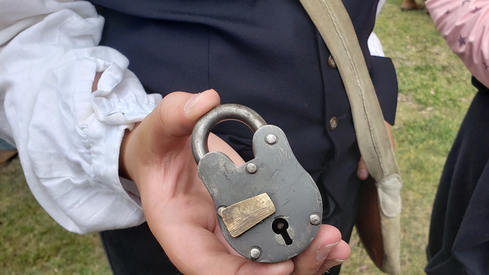 Paden Hamilton holds up a period padlock. His family was among those keeping blacksmith Jesse Colton busy.