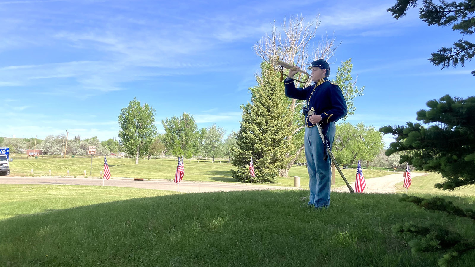 A bugler dressed in 1860s period uniform plays taps at a special ceremony at Fort Caspar on Saturday to honor nine soldiers who were lost to history and now have headstones.