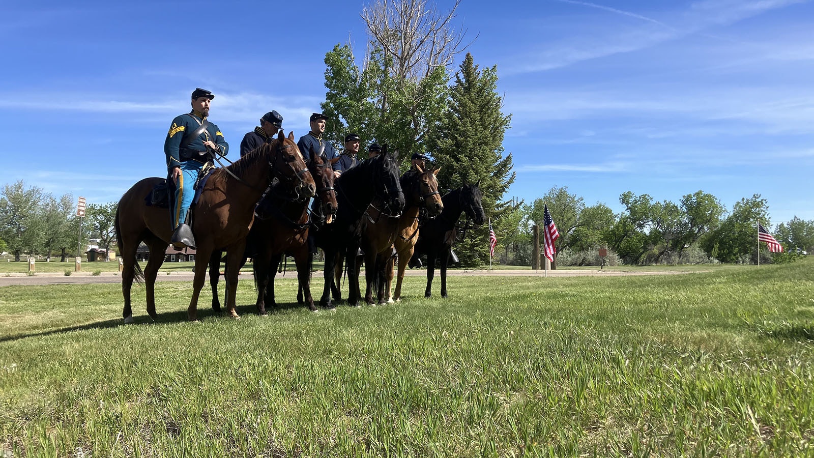 Reenactors portraying the 11th Ohio Volunteer Cavalry prepare for a ceremony on the ground of Fort Caspar honoring nine soldiers who died in 1865.