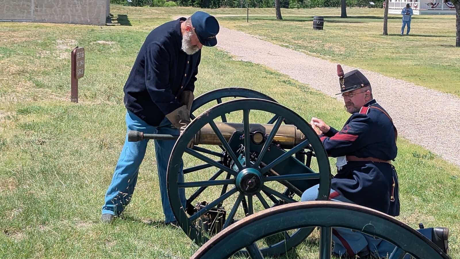 Volunteers load an 1841 Howitzer cannon that was fired as part of the Independence Day celebration at Fort Laramie National Historic Site.