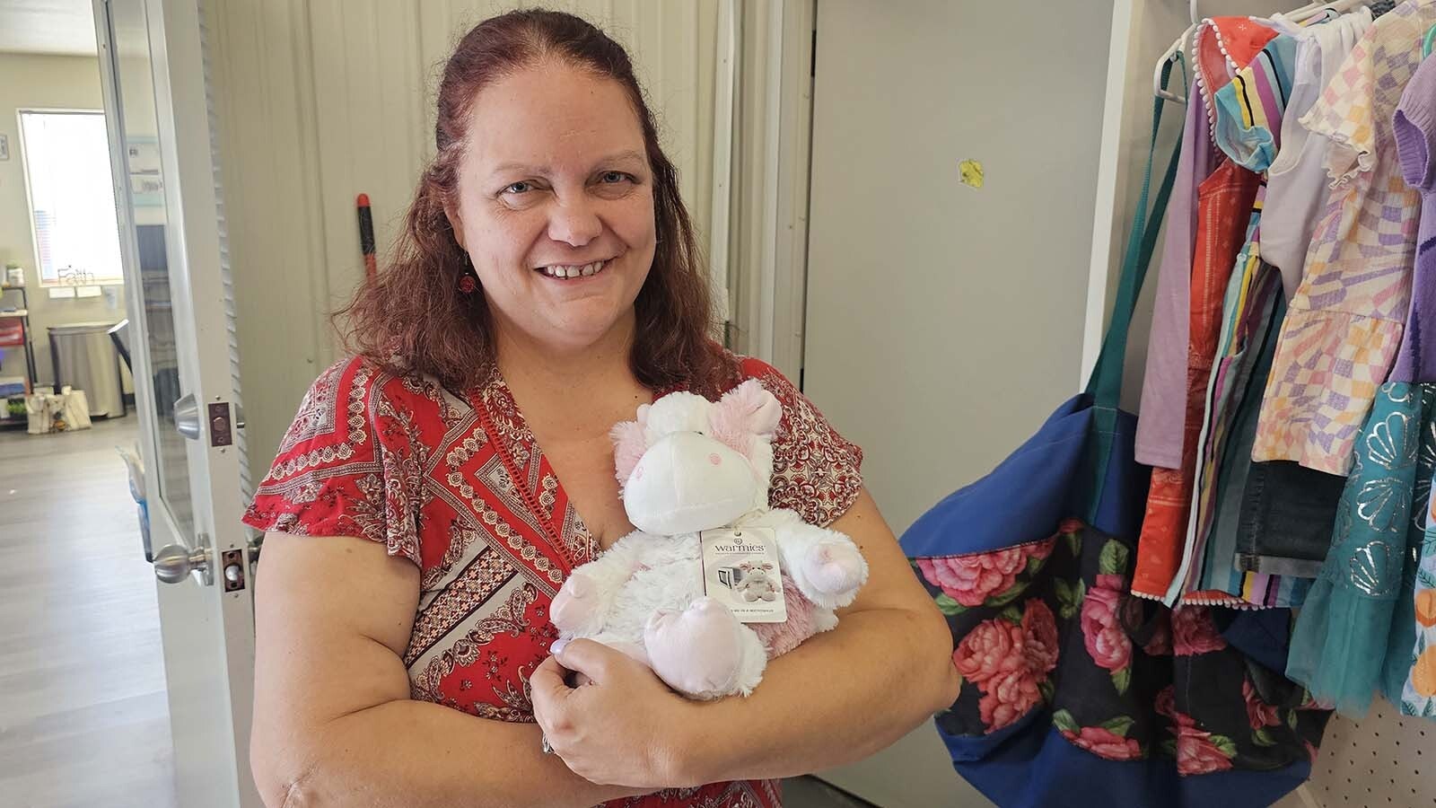 Carla Crayton hugs a "warmie," which is a plush stuffed animal with lavender inside it. It can be heated in the microwave so it is warm, and the scent it gives off is supposed to be calming.
