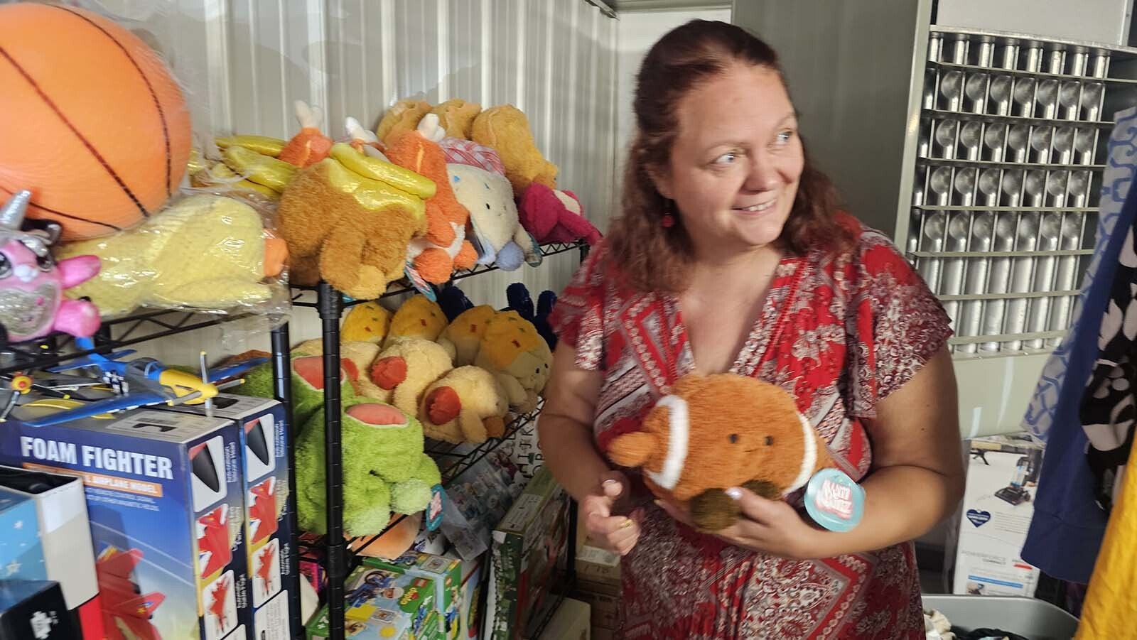 Crayton picks up a stuffed animal in the gift area of the Sheridan Foster Care Exchange.
