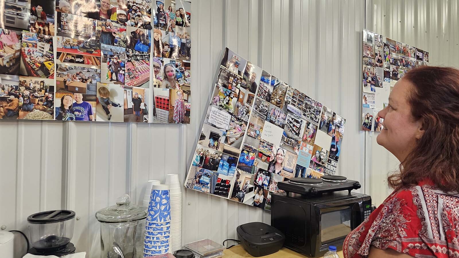 Crayton smiles at all the photographs and memories, hangin got the walls at the Sheridan Foster Care Exchange.