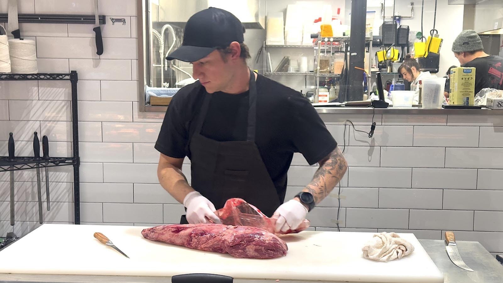 Shane Cartularo cuts a Christmas beef tenderloin during the holiday rush at Primal Meat & Fish Market.