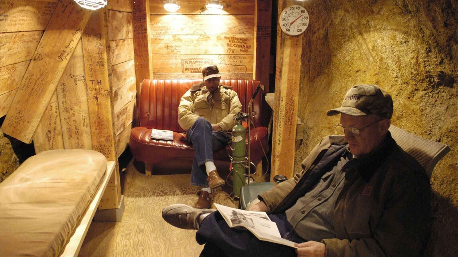 Ted Kaddy, 87, rear, and Bob Domgard, 61, both of Whitehall, Montana, sit in the Free Enterprise Mine for Health in Boulder, Montana, in this 2004 file photo. They say that radon has relieved their arthritis.