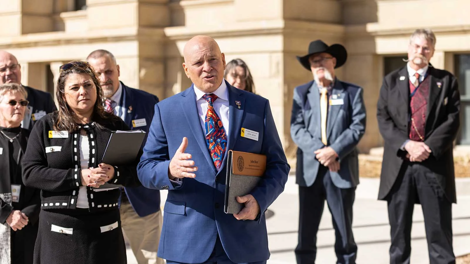 People are blaming — and crediting — the Wyoming Freedom Caucus for the Wyoming Legislature’s nearly $4 billion school spending package. Whether the caucus deserves either depends on whom you ask. It had “overwhelming support” across the Legislature. Above, Freedom Caucus members outside the state Capitol in Cheyenne during the 2026 legislative session.