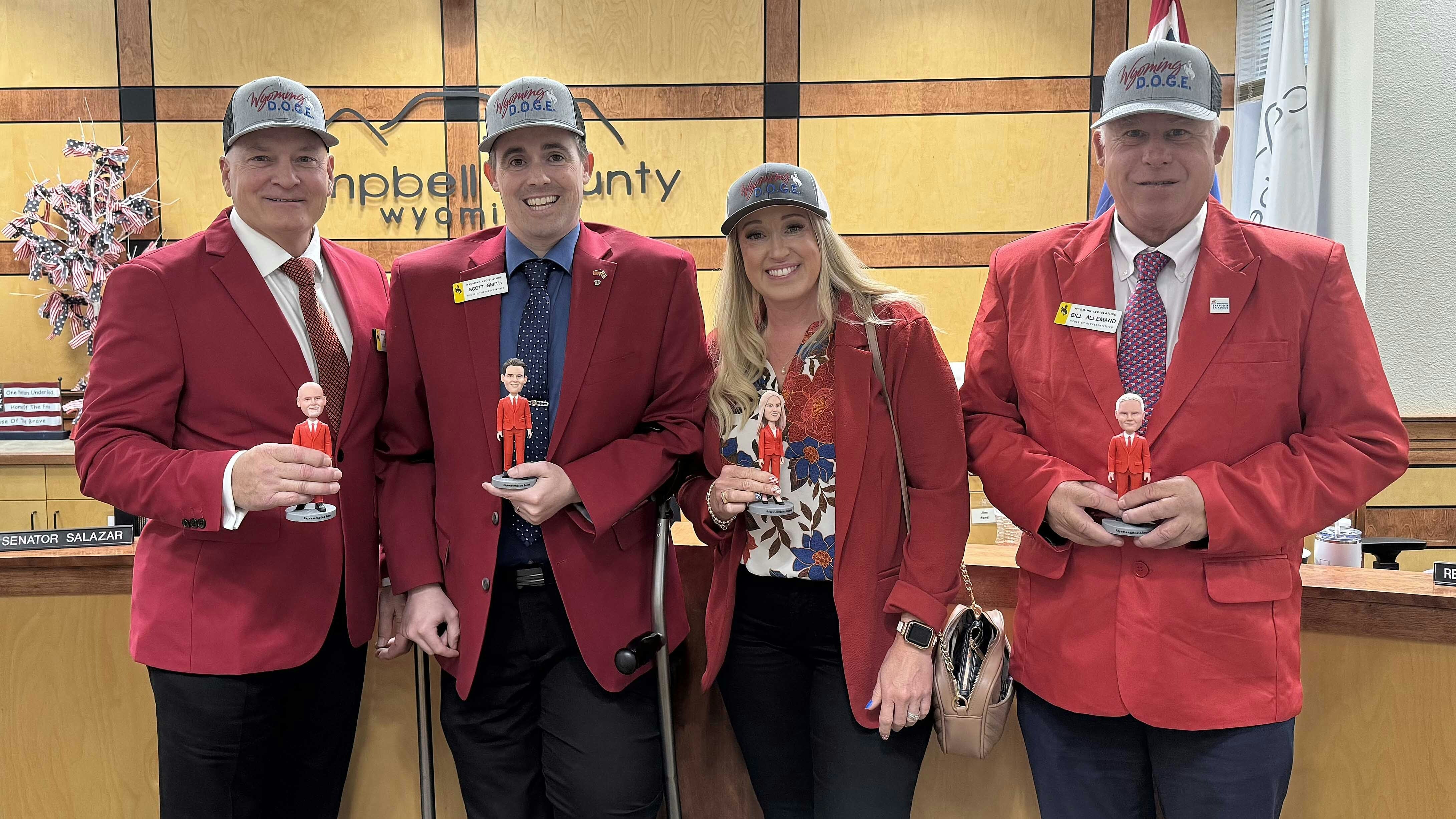 Some Wyoming House members donned red jackets Tuesday to a Legislative committee meeting as a warning of a projected nearly $700 million deficit. Detractors of the visual protest say those same lawmakers helped gouge state revenues. They are, from left, Republican Reps. John Bear (Gillette), Scott Smith (Lingle), Abby Angelos (Gillette) and Bill Allemand (Casper).