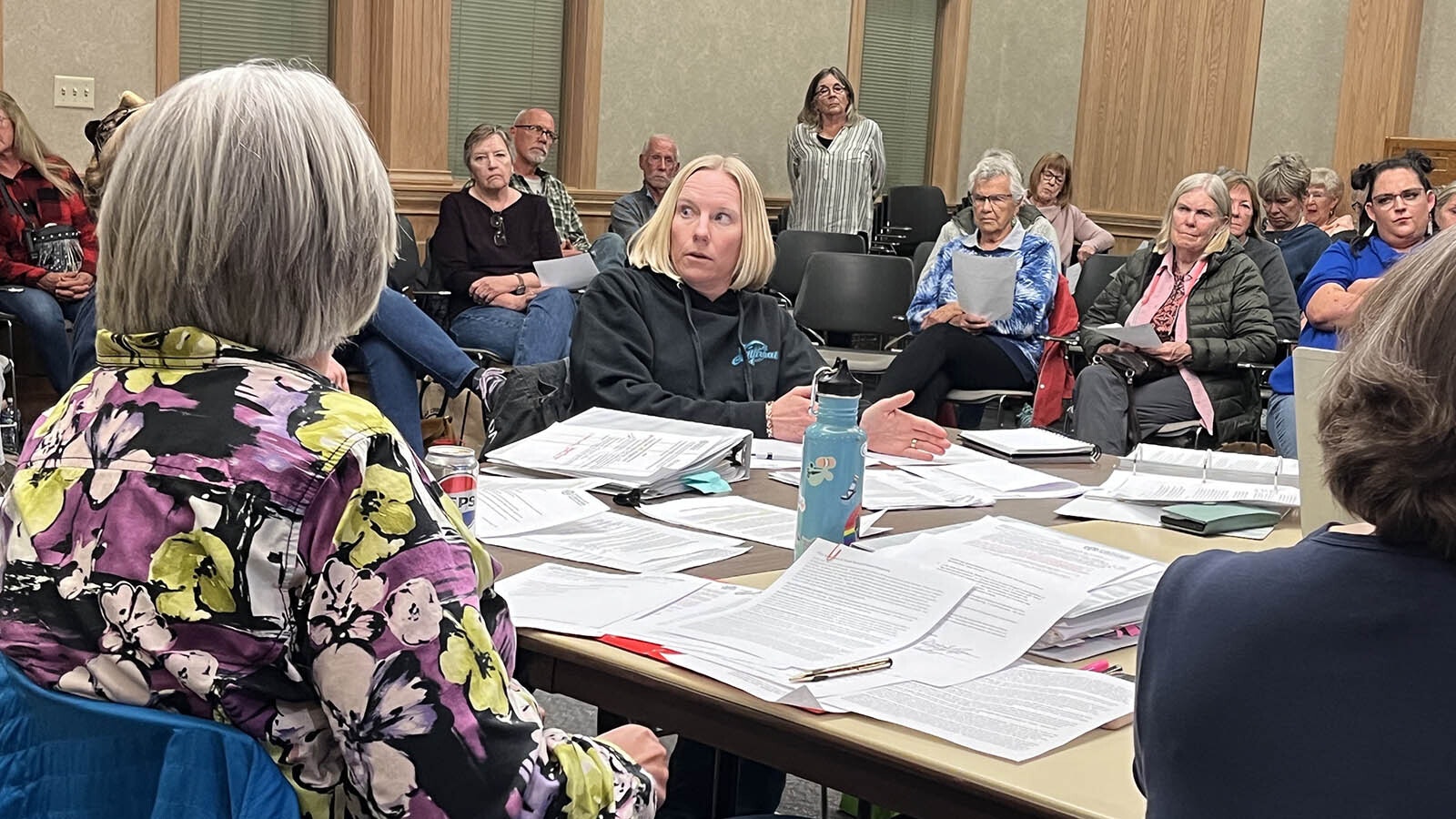 Fremont County Library Board Chair Carrie Johnson, back-facing, and board member Kristen McClelland, center, sparred over whether the library should implement parental checkout restrictions.