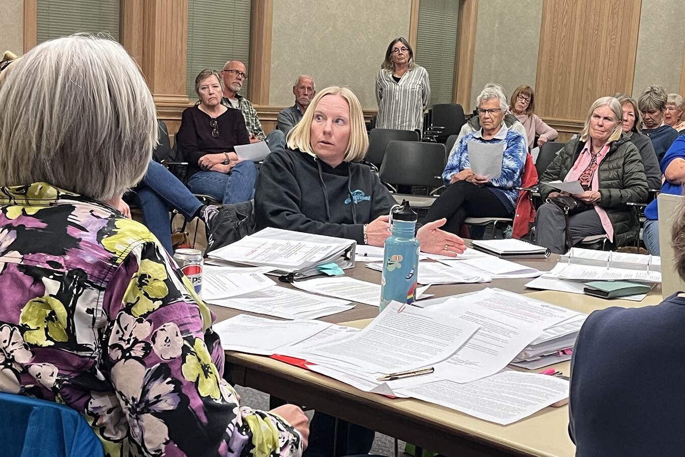 Fremont County Library Board Chair Carrie Johnson, back-facing, and board member Kristen McClelland, center, sparred over whether the library should implement parental checkout restrictions.