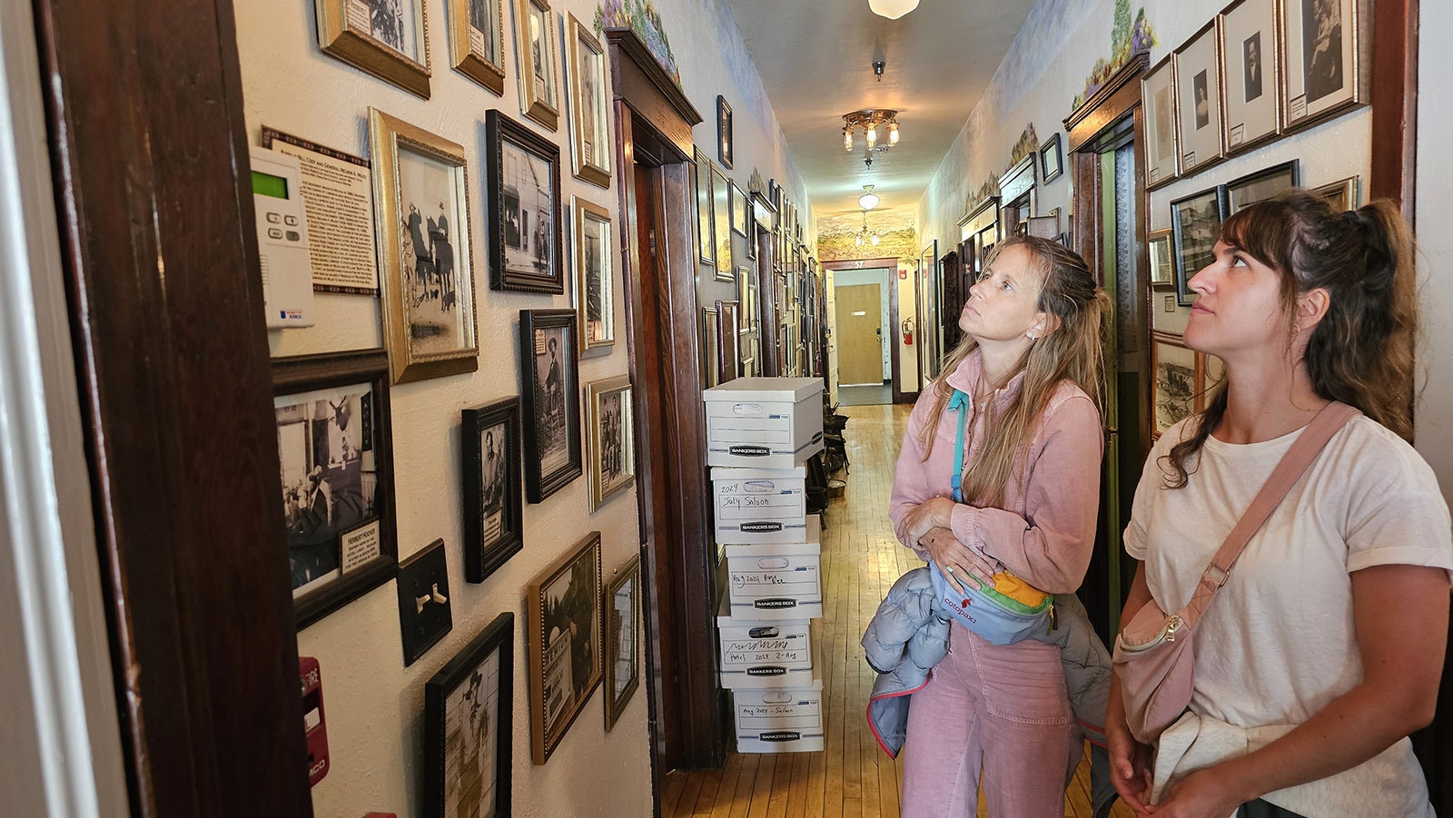 Domiziana Antamoro and Alexandra Seon look at historical photos displayed at the Occidental Hotel in Buffalo.