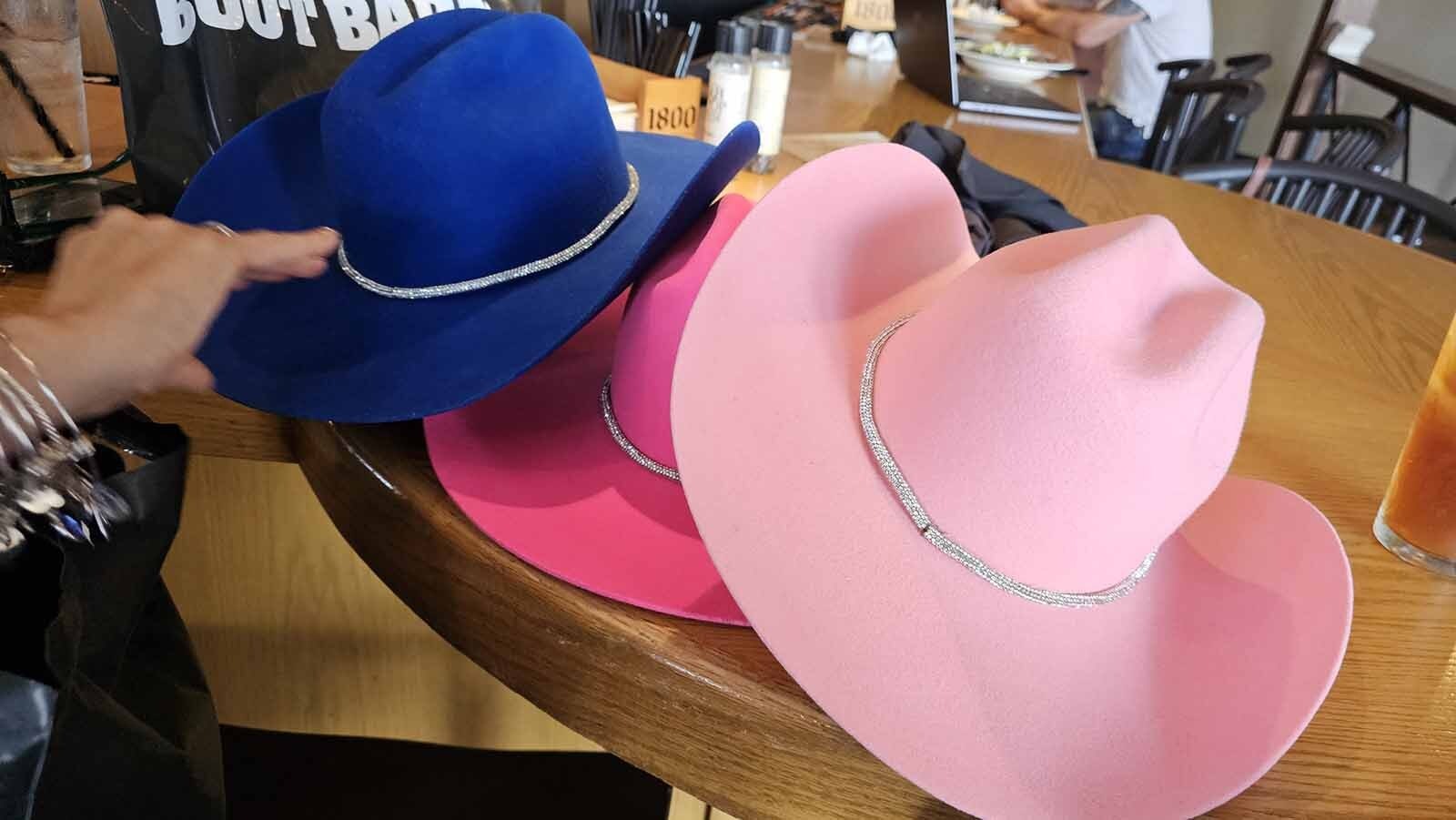 Cowboy hats in three different colors were among items bought by visitors Beth and Craig Lemonowicz.