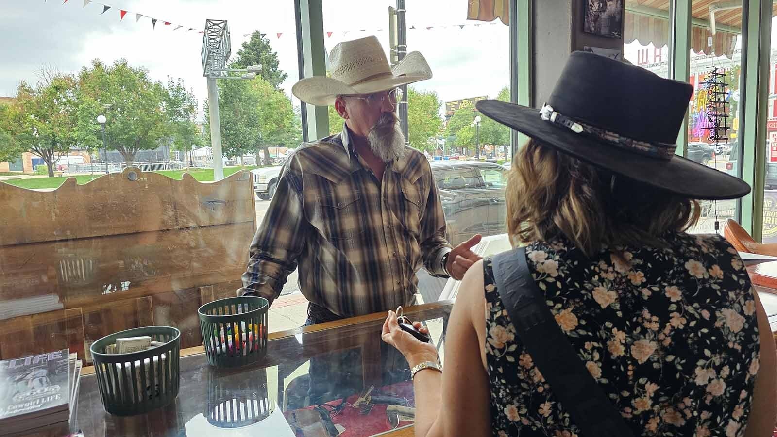 Michael Magill, owner of The Cowboy Emporium at The Plains, talks with a customer about knives. The new business had as as few as two customers per day before Cheyenne Frontier Days. Since then, it's seeing more like 100 every day, a huge help for a brand-new business.