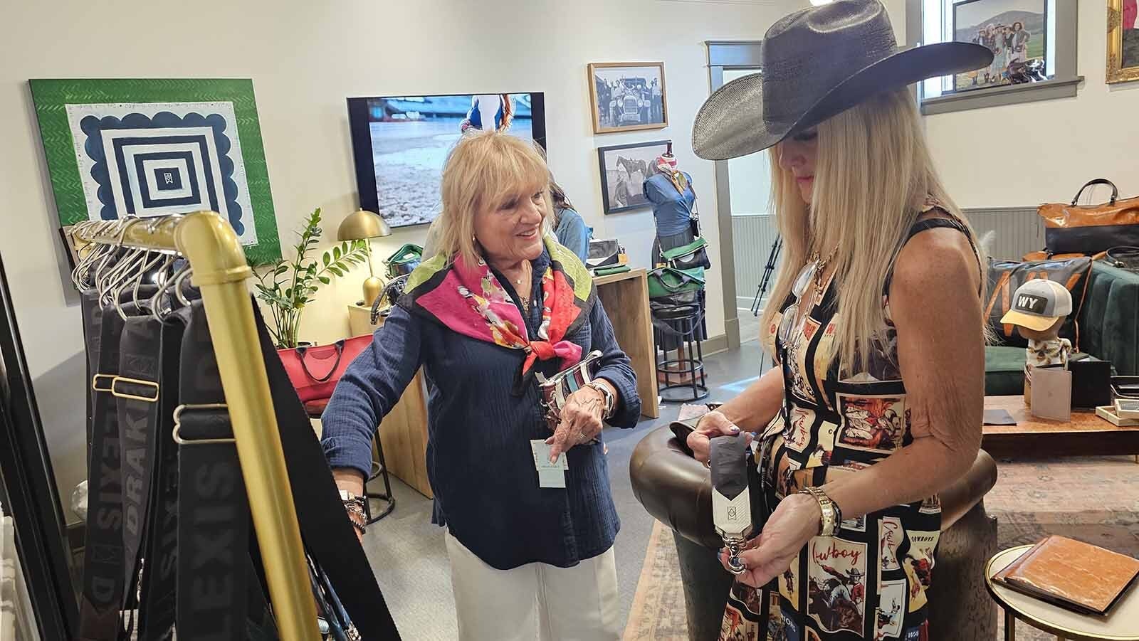 Shelli Gladfelder, right, from Logan, Utah, looks at a strap for the purse she bought at Alexis Drake in Cheyenne, a boutique which offers customizable leather goods ranging from belts and bags to purses and wallets. There are also hats, scarves, and other accessories.