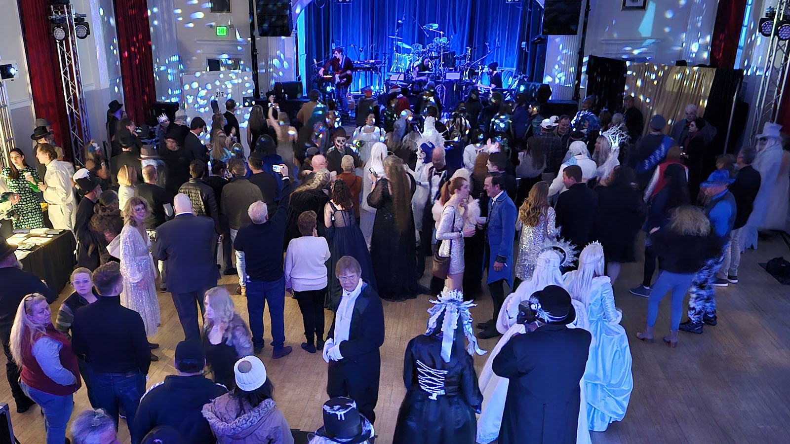 A ballroom full of people dressed in undead costumes twirl around to music during the Blue Ball.