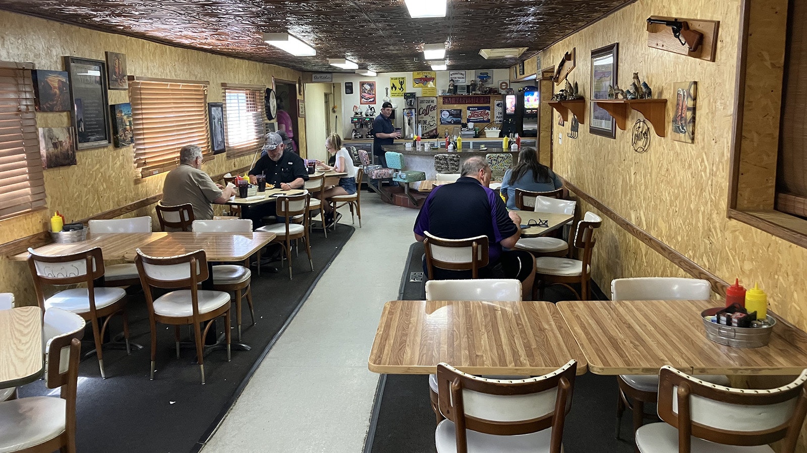 G-Ma’s Diner’s interior features an old-style metal ceiling and Western and classic diner images on its walls.