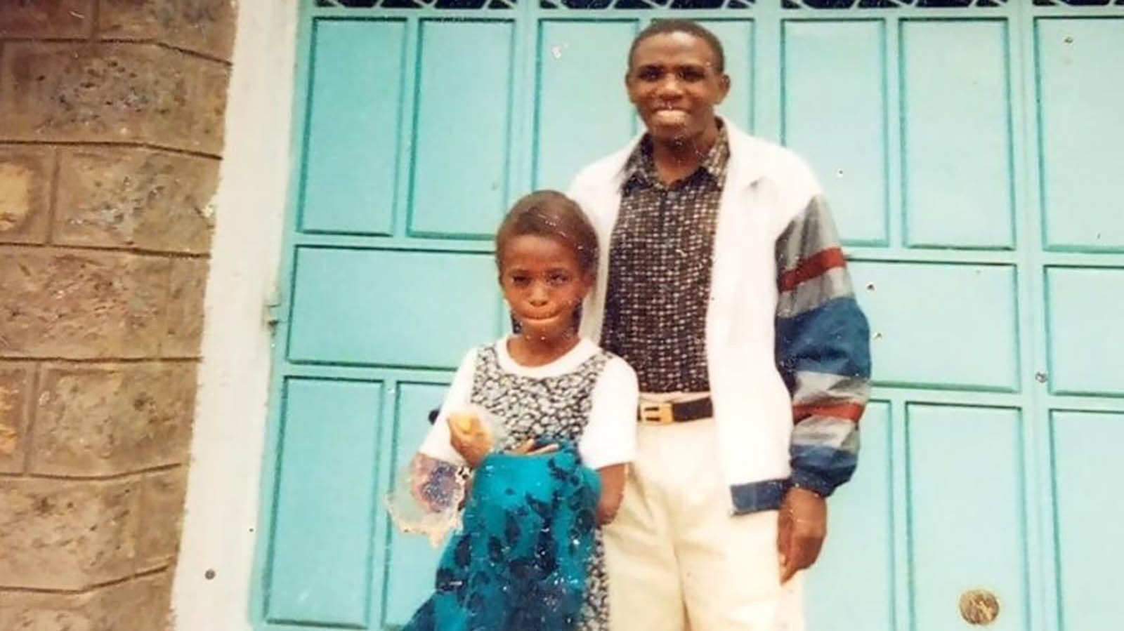 A young Irene Gakwa stands with her father, Francis Kambo, in Kenya.