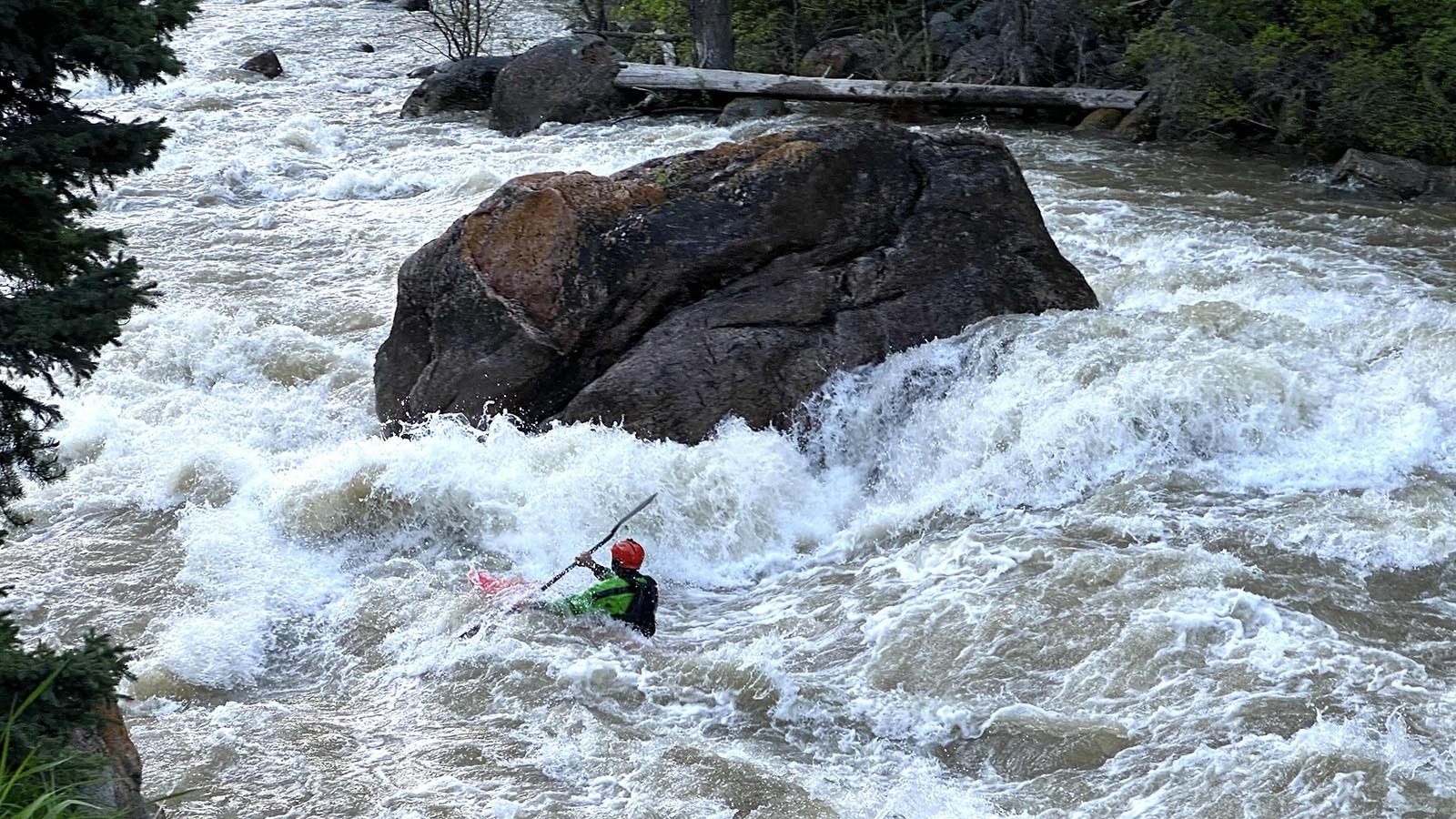 A boater paddles past House Rock, the most notable feature on a popular stretch of whitewater outside Bozeman, Montana, in the Gallatin Canyon.