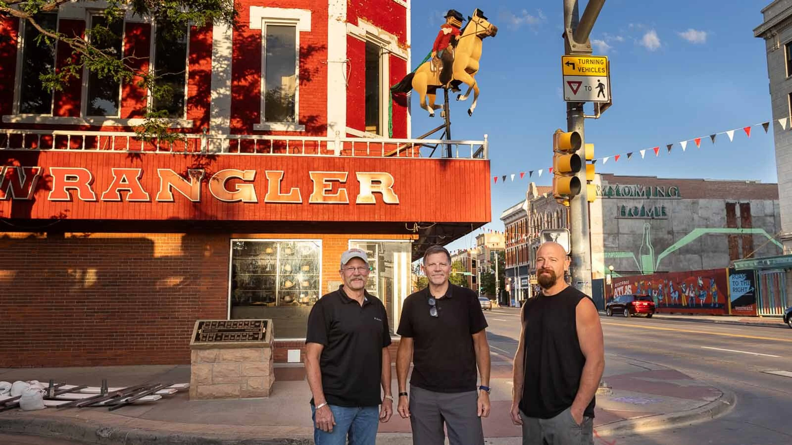 A repaired and refurbished Galloping Horse was put back into place about the entrance to The Wrangler in downtown Cheyenne on Thursday, July 16, 2026. The work was done by Patrick, from left, Dennis and Brandon Graham.