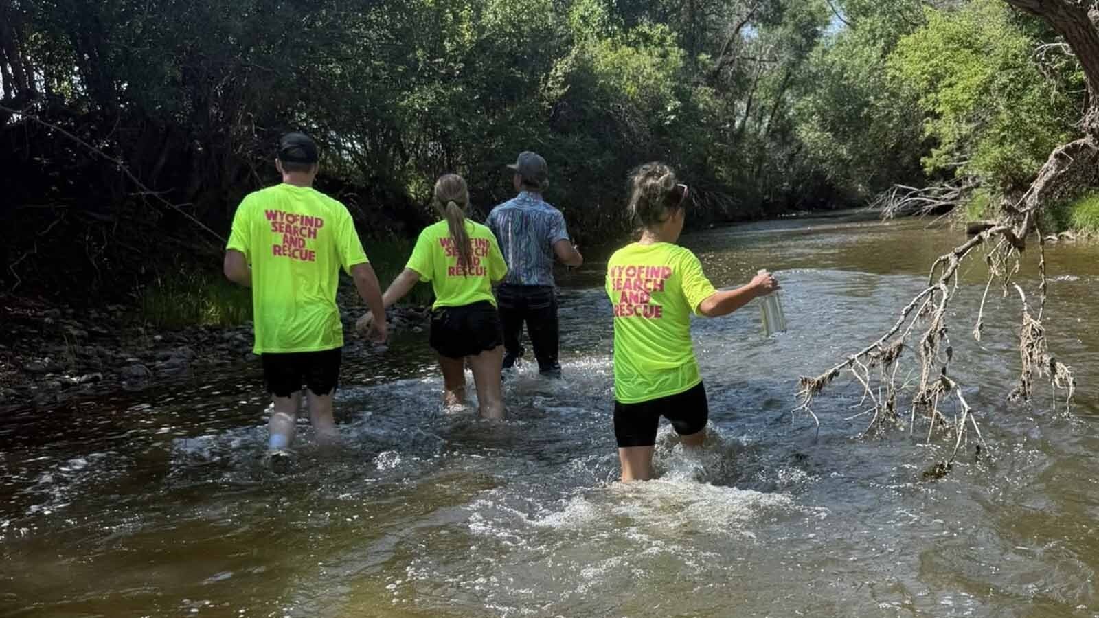 A group of volunteers — including James Galloway's daughter and step-daughter — walk through Big Goose Creek looking for his clues as to what happened to him.