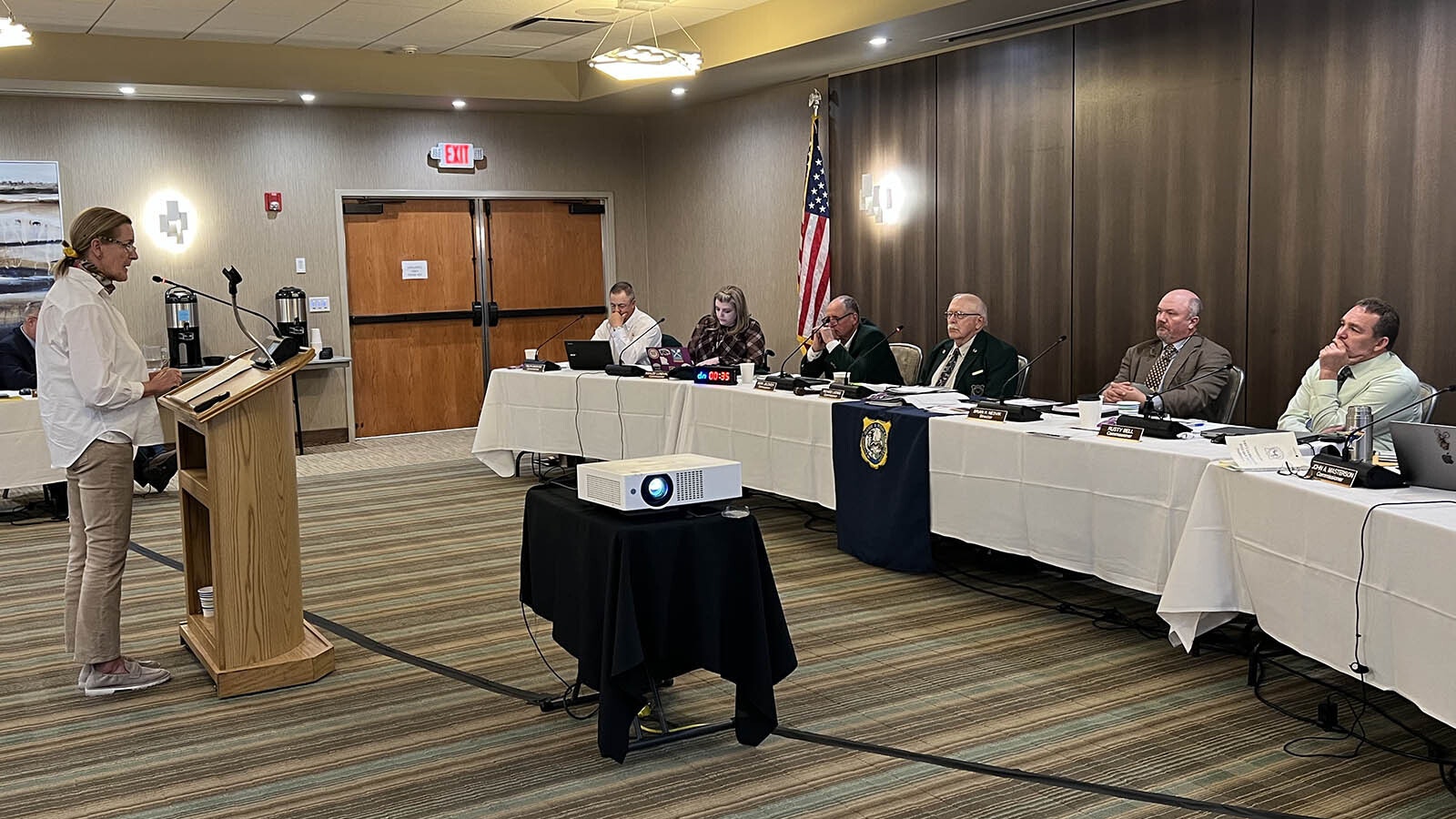 Wyoming Game and Fish Department Director Brian Nesvik and members of the Wyoming Game and Fish Commission listen on Wednesday as Lisa Robertson of Wyoming Untrapped speaks about the abuse and killing of a wolf in Daniel.