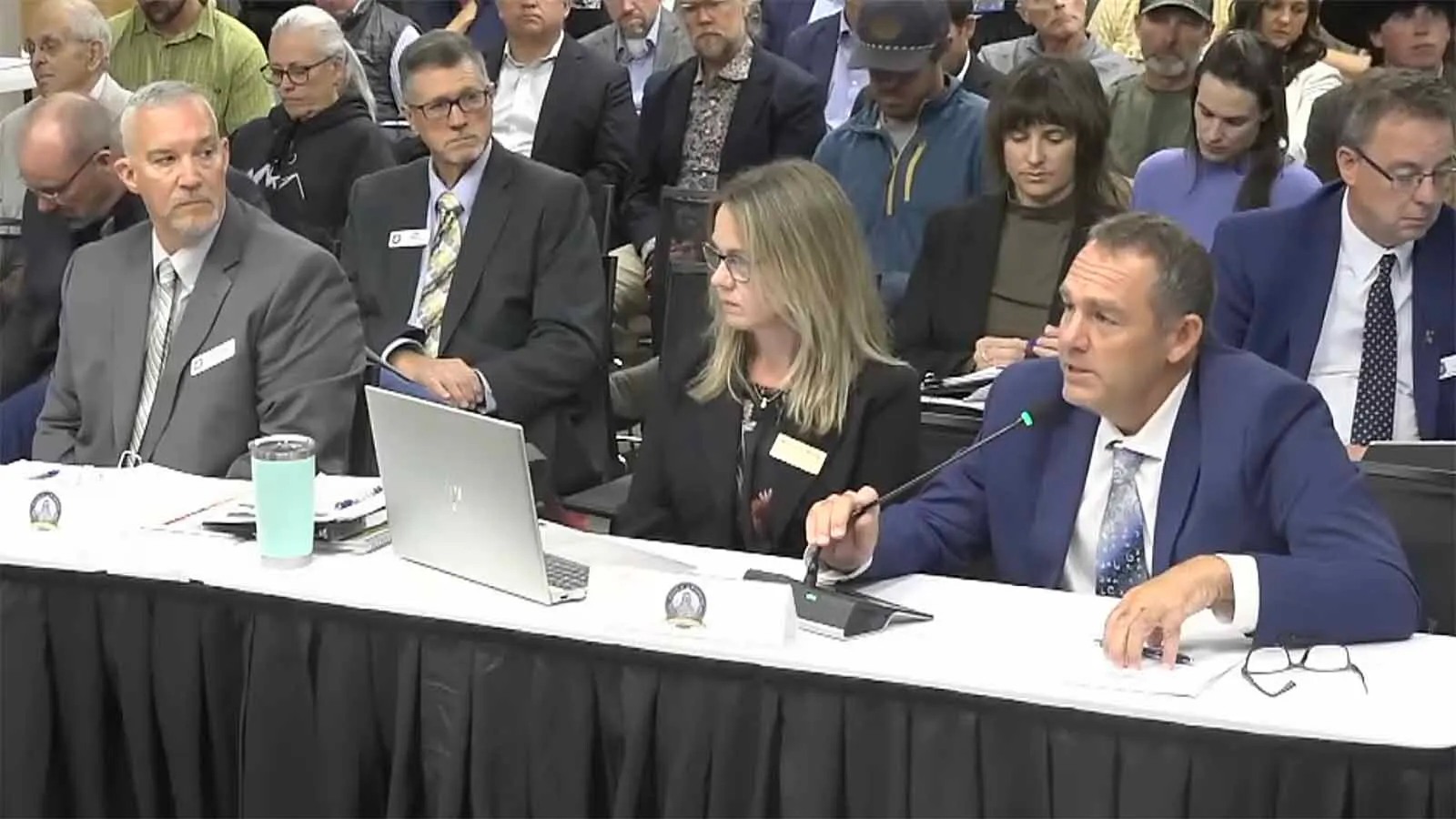 Wyoming Game and Fish Game and Fish Interim Director Eric Wiltanger, Game and Fish CFO Meredith Wood, and Game and Fish Commissioner Rusty Bell speak with legislators Wednesday in Jackson.