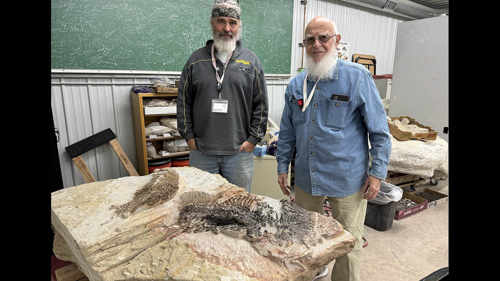 J.P. Cavigelli and Dwaine Wagoner with a sandstone block containing three 50 million-year-old gar skeletons from the Wasatch Formation. Wagoner spent 300 hours removing the sandstone encasing the remarkably well-preserved fossils found on a ranch in Converse County.