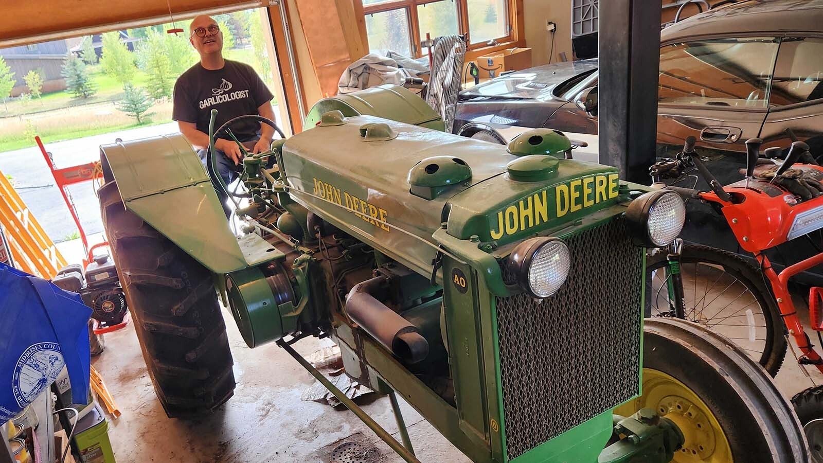 Michael Scheller uses a variety of tractors to till the earth for planting garlic.