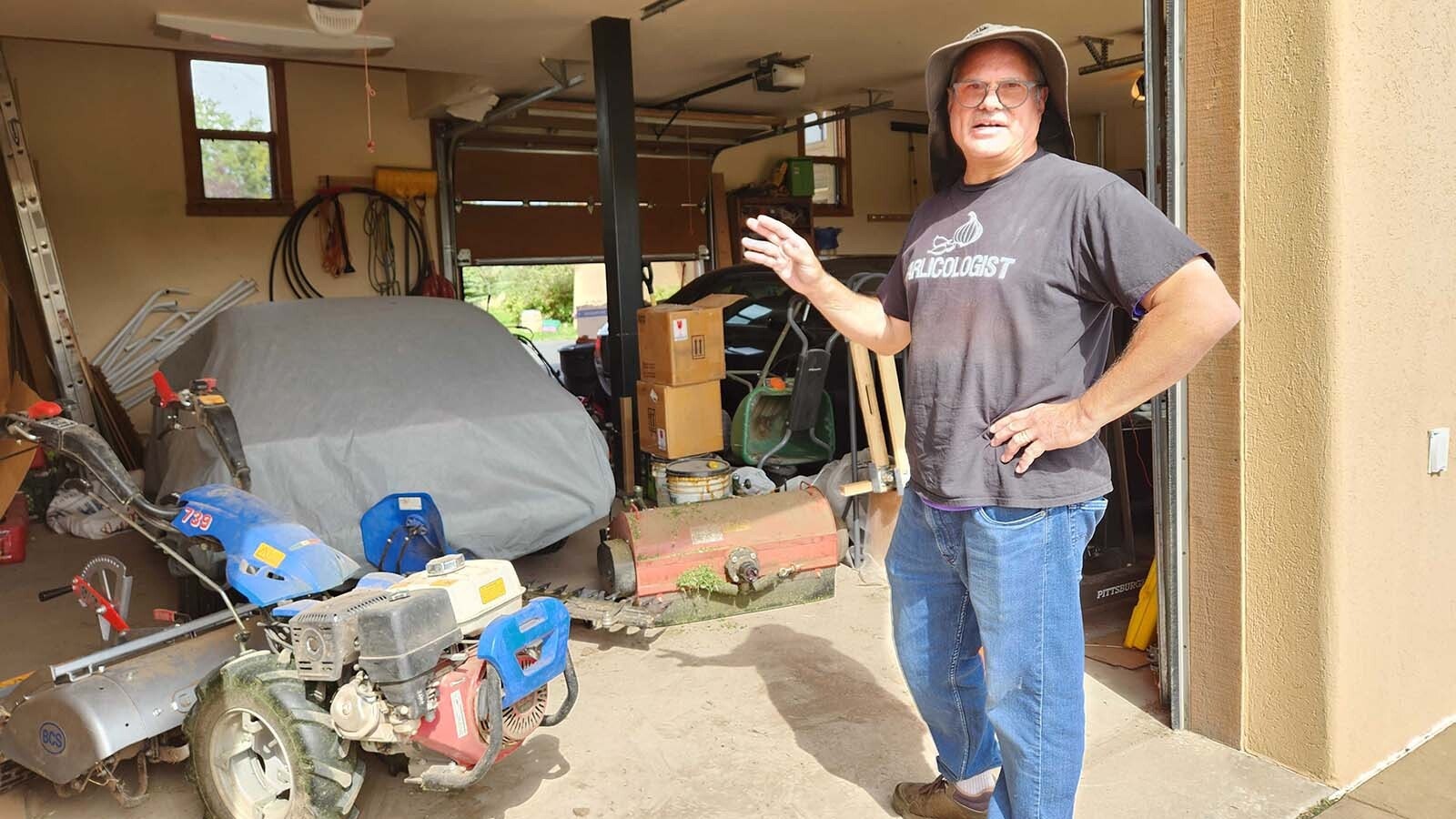 Michael Scheller uses a variety of tractors to till the earth for planting garlic.