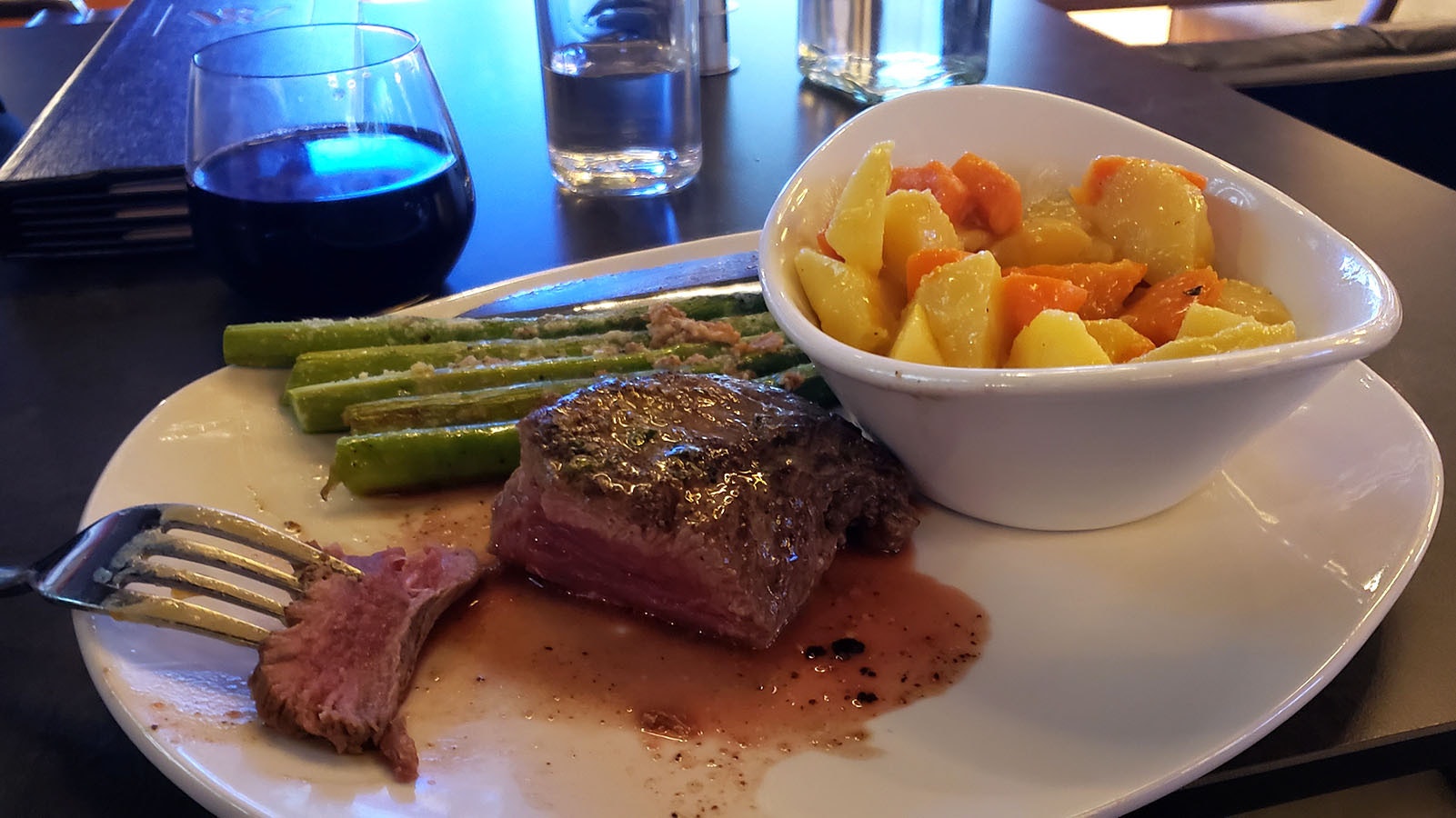 Wyoming beef perfectly prepared and very tender with asparagus and a dish of roasted turnips and carrots. A selection of good red wines are available to go with the meal.