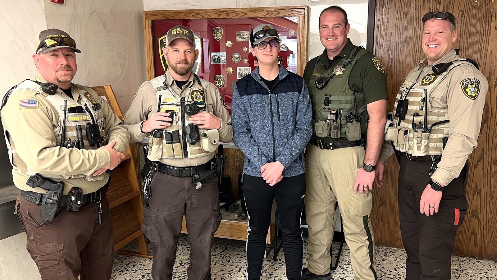 Gavan Bethel, center, recently visited the Natrona County Sheriff’s Department to thank first responders involved in saving his life last May. They include from left, Deputy Chris Mikels, Sergeant Brad Legler, Wyoming Highway Patrol Lieutenant Clint Christensen, and Deputy Dan Beall.