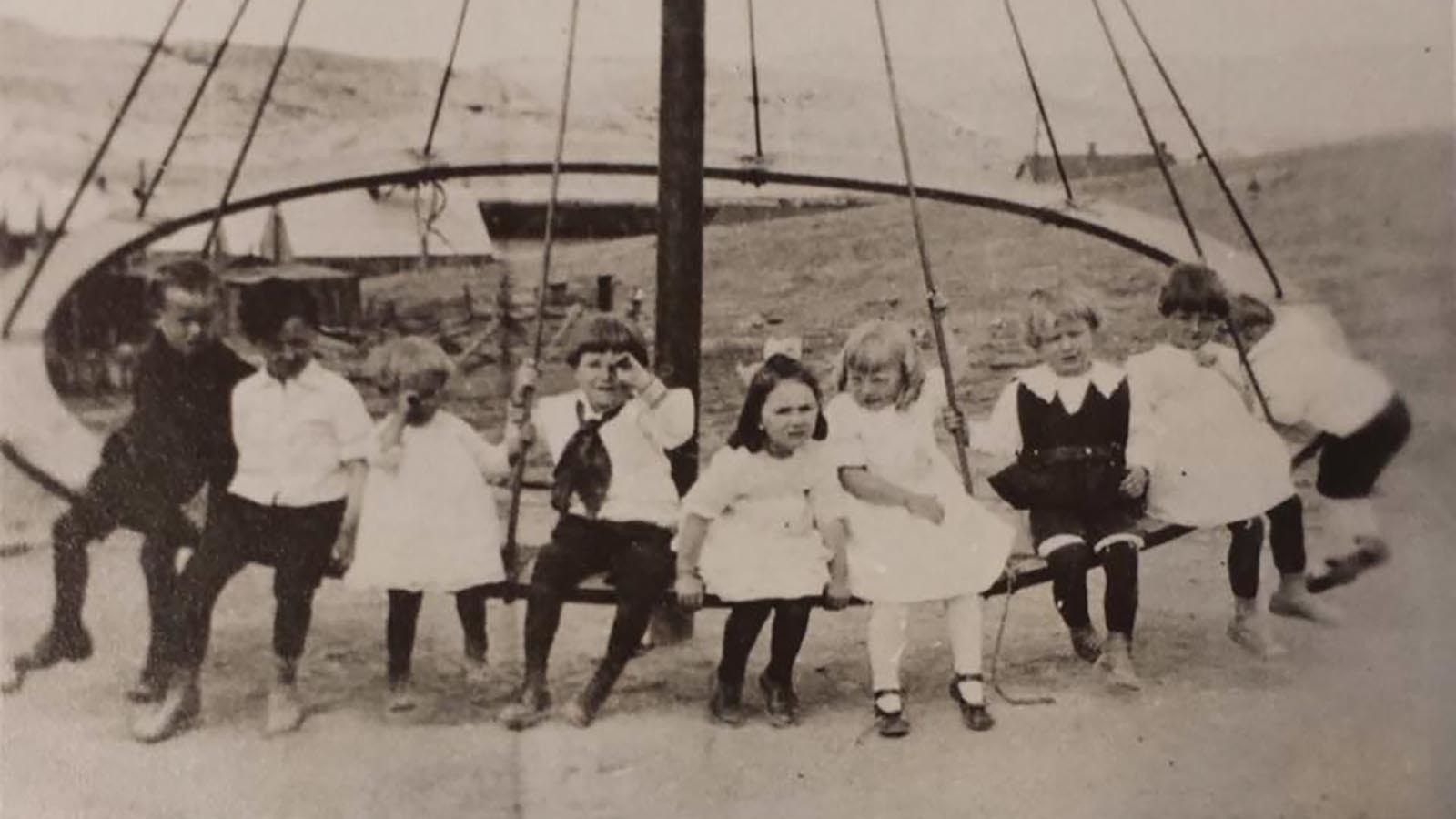 A group of children on a playground in Gebo, Wyoming.