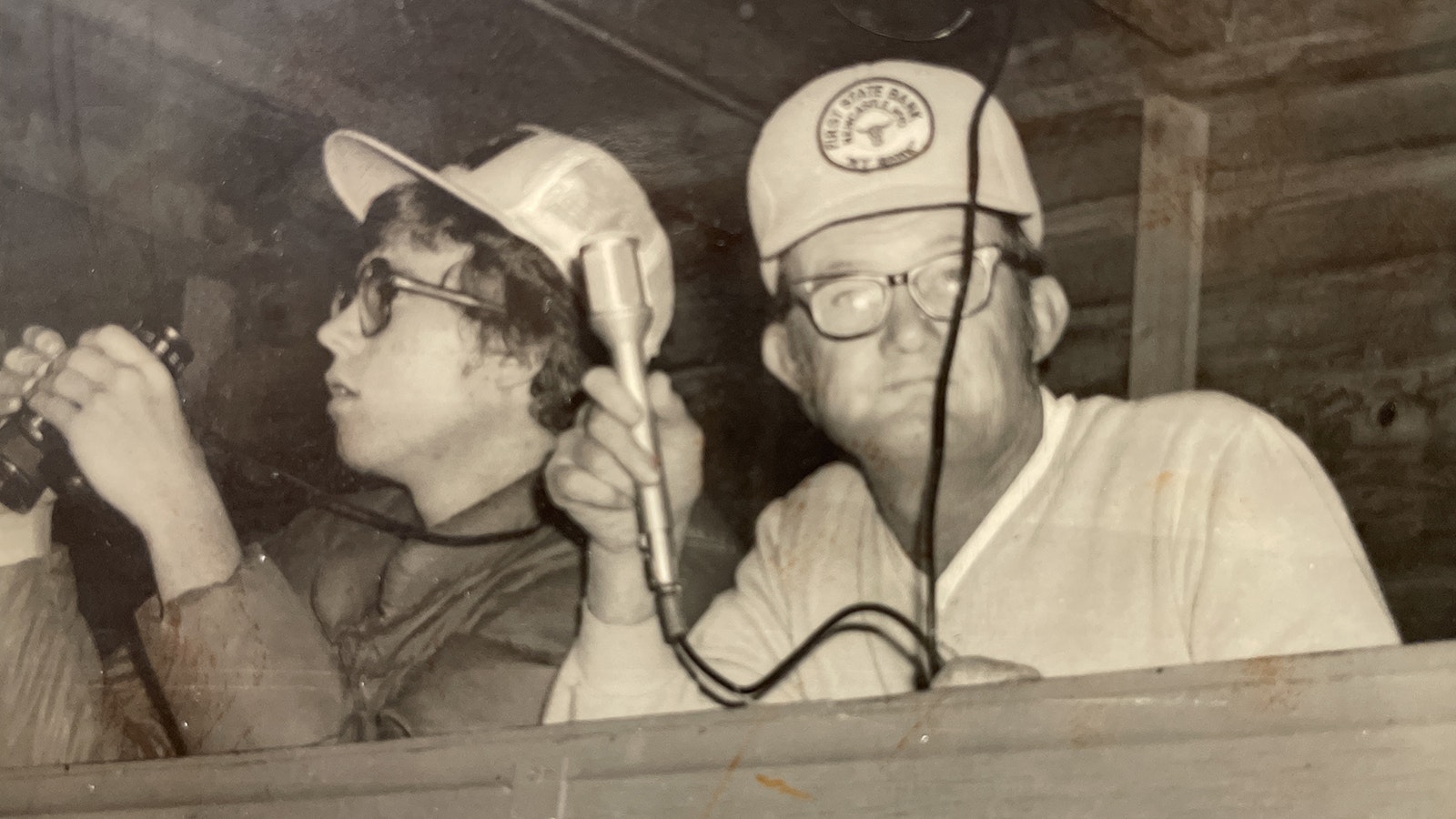 Gene Baldwin became the “Voice of the Dogies” after years of announcing the Newcastle High School football games. He would get help spotting from members of the community and is pictured with his son, Bob, spotting.