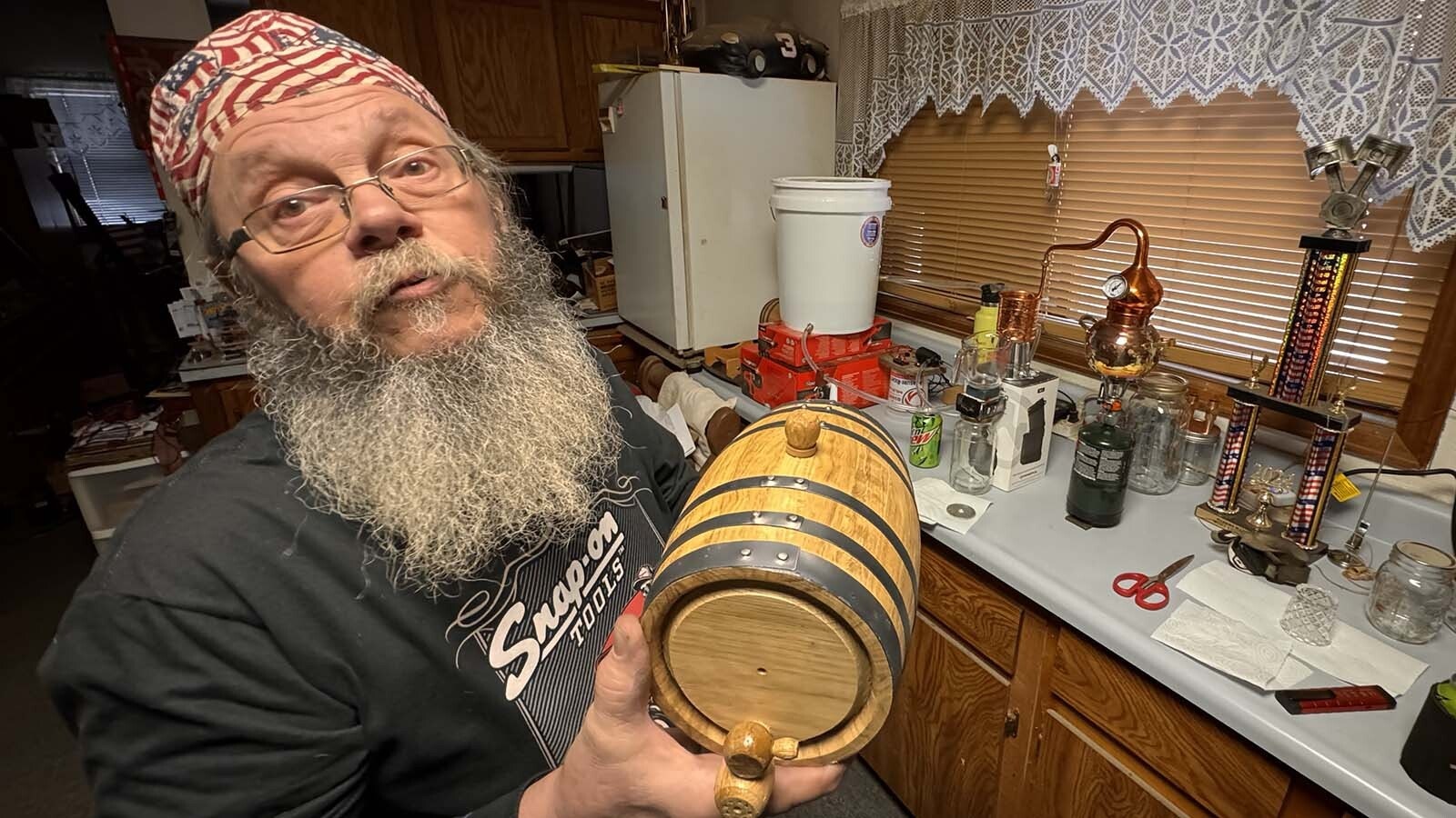 After watching the Discovery Channel show "Moonshiners," Cheyenne mechanic Geno Stecks was inspired to try it on his own. So far, his tiny hobby moonshine still has produced about 1.5 cups of hooch since December. At that rate, he thinks it'll take "about a year" to fill one of his tiny 2-liter oak kegs.