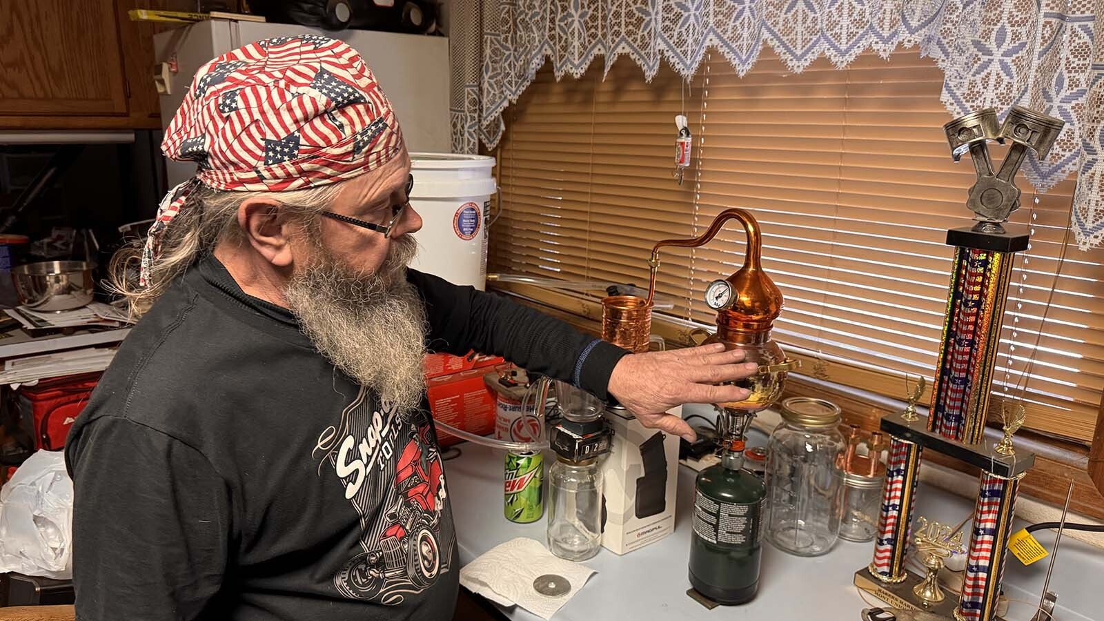 After watching the Discovery Channel show "Moonshiners," Cheyenne mechanic Geno Stecks was inspired to try it on his own. So far, his tiny hobby moonshine still has produced about 1.5 cups of hooch since December. At that rate, he thinks it'll take "about a year" to fill one of his tiny 2-liter oak kegs.