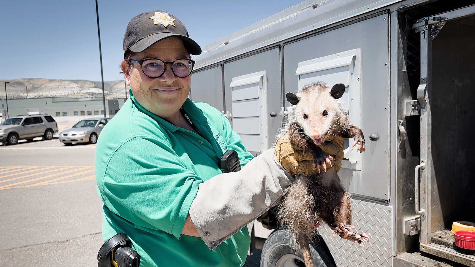 A Sweetwater County animal control officer holds George, a pesky opossum that was living under a local resident's home in summer 2022.