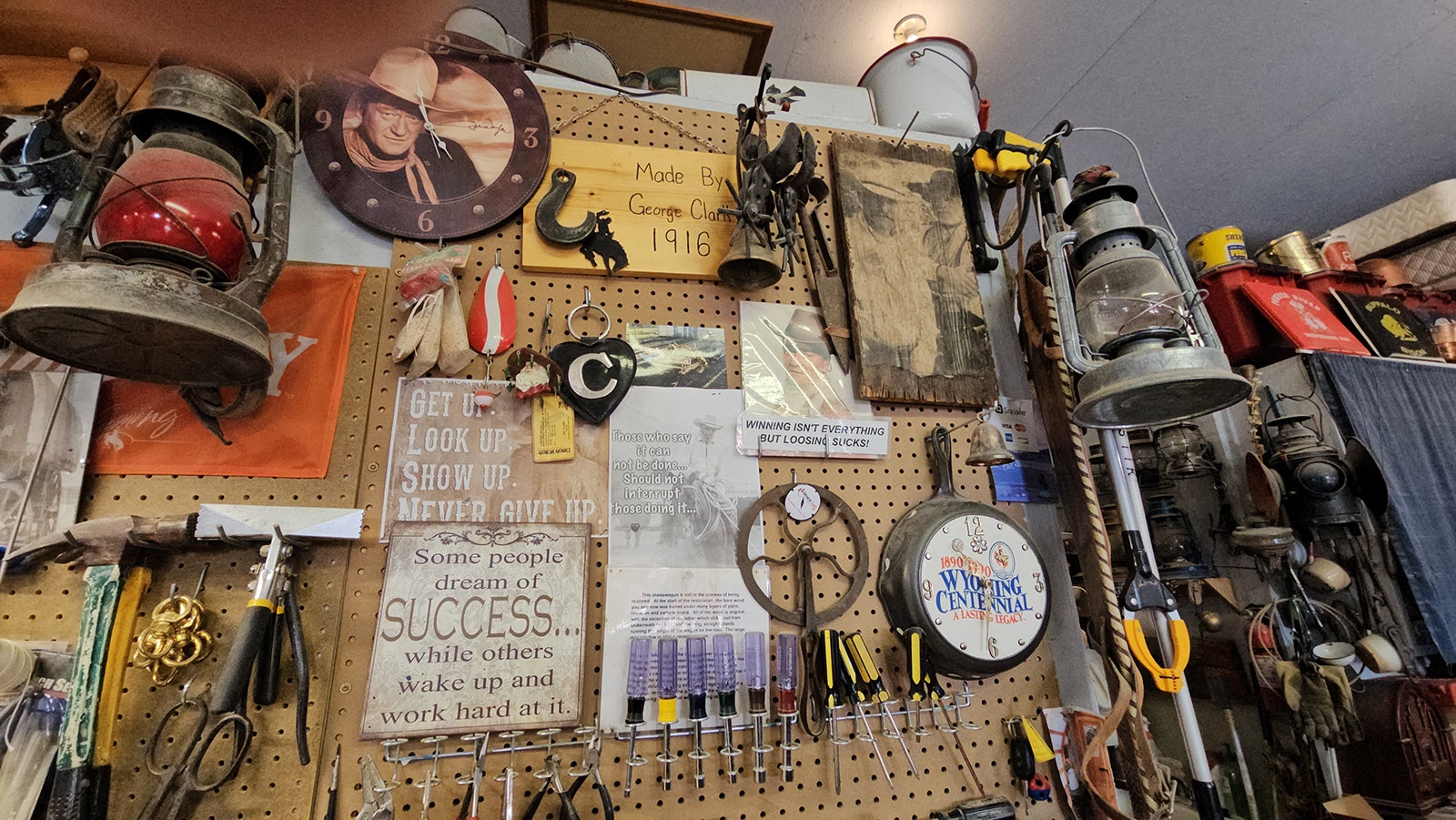 The walls of George Clark's shop in Buffalo include inspiring quotes as well as mementos from family members, and pictures of John Wayne.