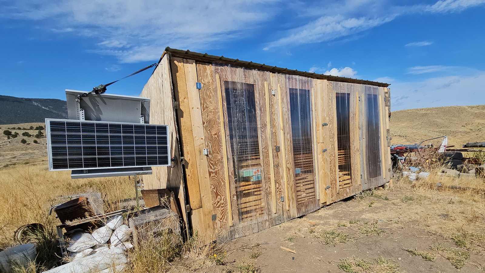 A homemade wood-drying kiln, powered with a solar panel.