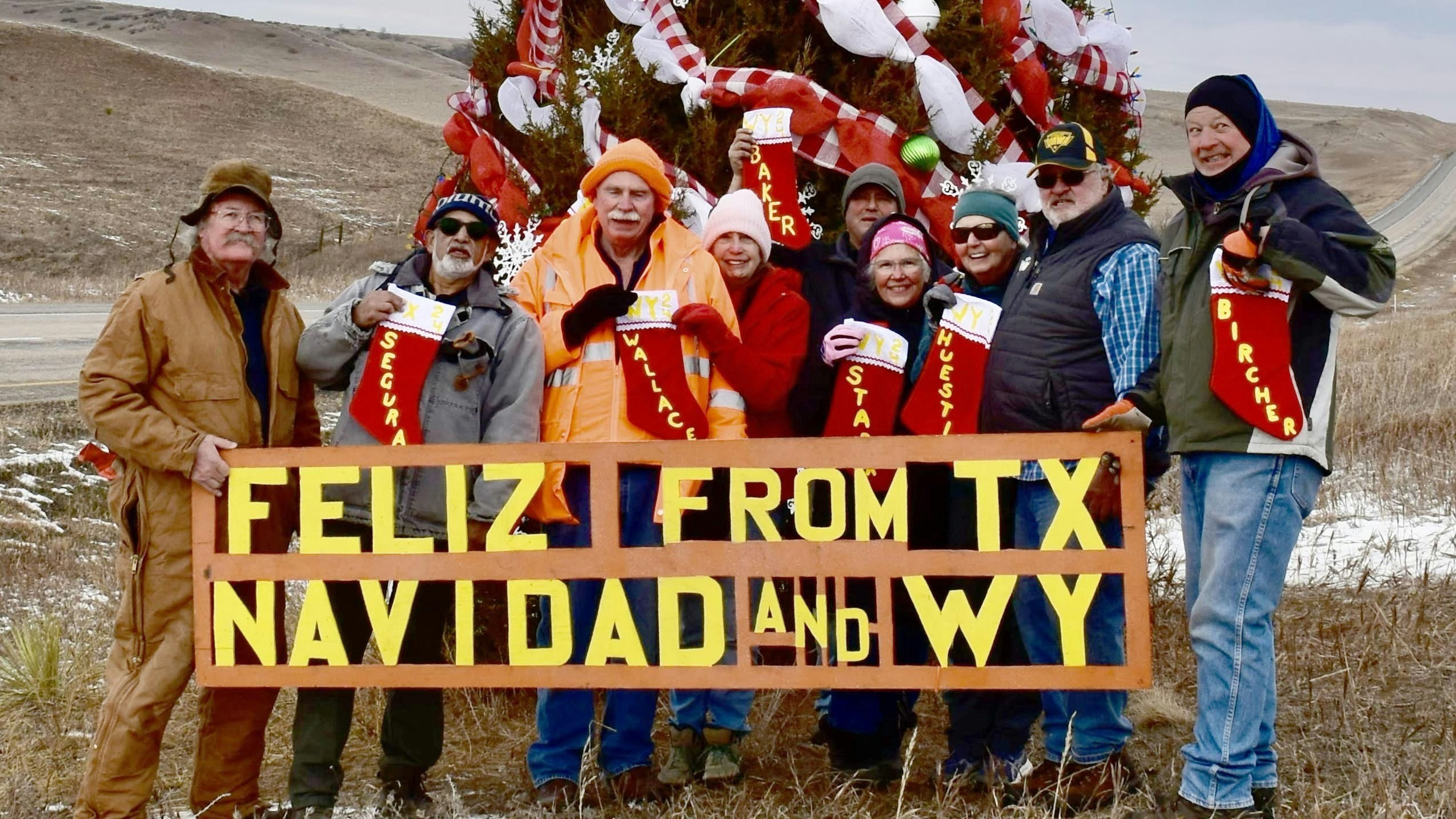 For the 15th year, German Segura, second from left, has decorated a lone tree in the median of Interstate 90 between Sheridan and Billings, Montana.