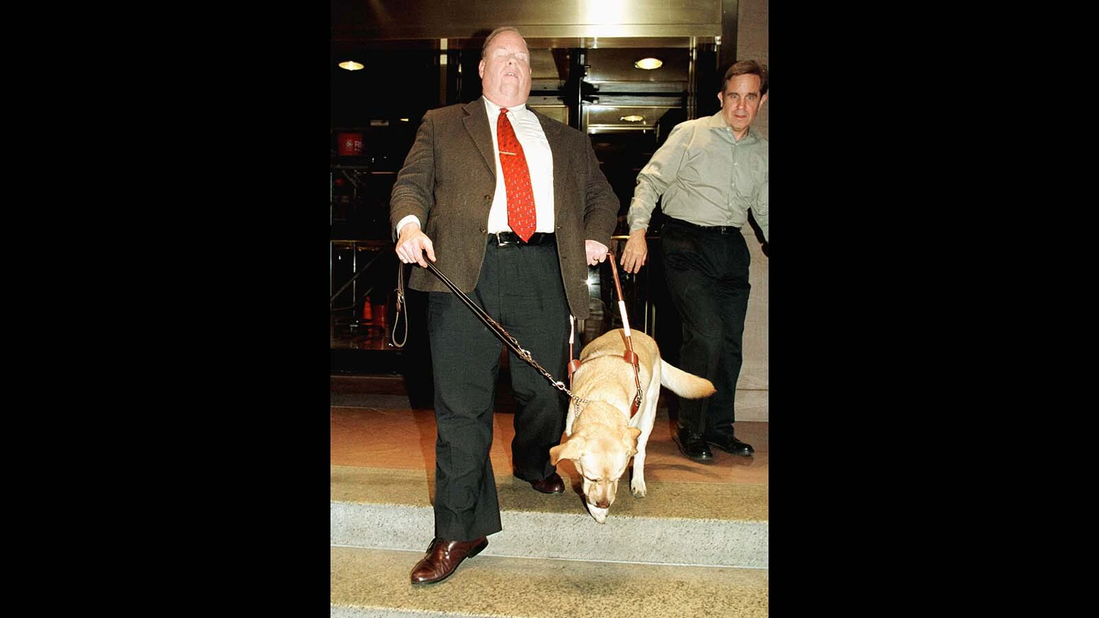 Michael Hingson and guide dog Rossele leave CNN Studios after appearing on a special Larry King Live Show titled, "America's New War" less than a month after the Sept. 11, 2001, terrorist attacks. Hingson, who is blind, survived the attack on the World Trade Center thanks to Rossele, who led him down 78 floors to safety.