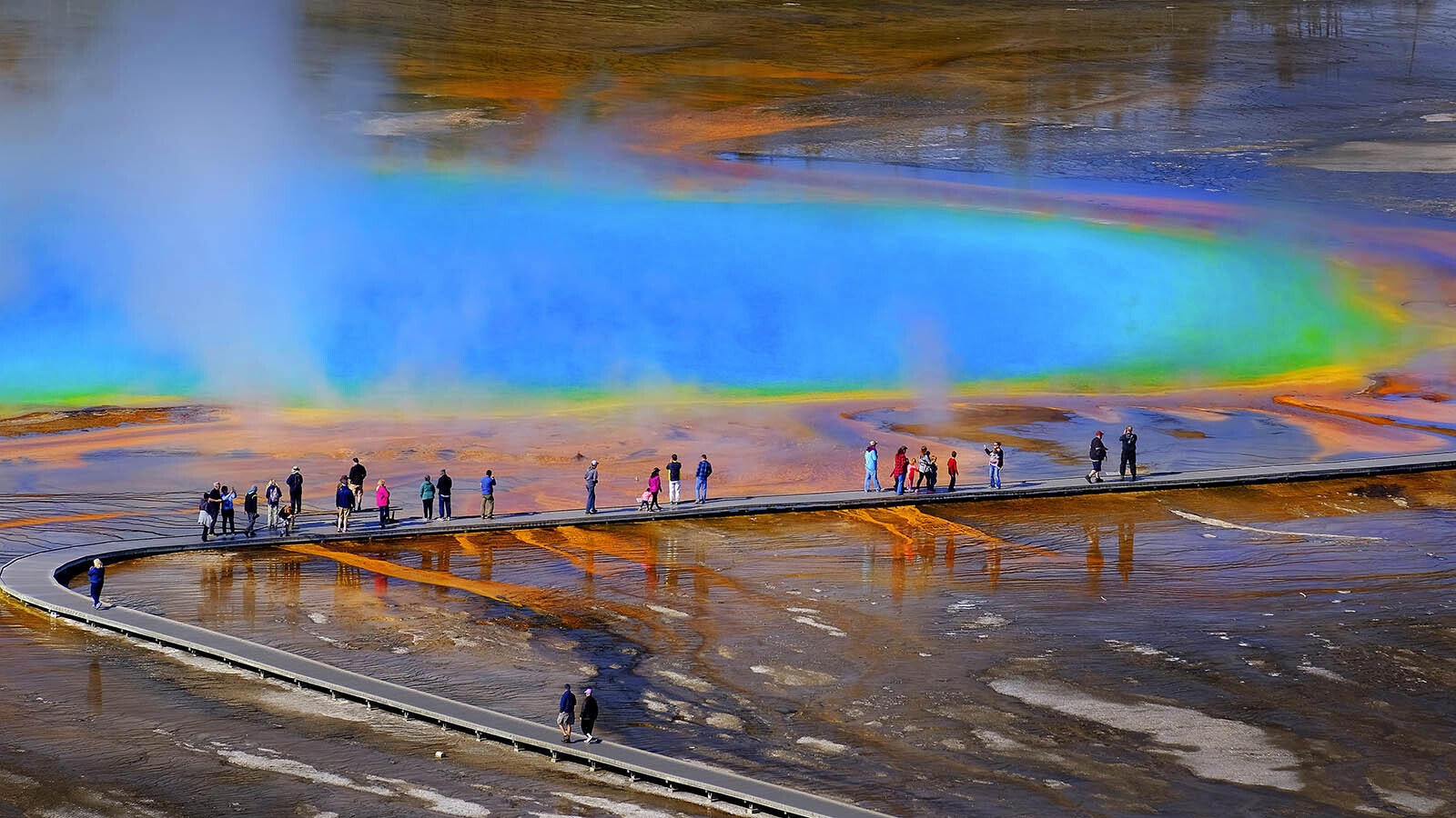 Visitors walk along the boardwalk at Grand Prismatic Spring in Yellowstone National Park, which has opened for the 2024 tourism season.